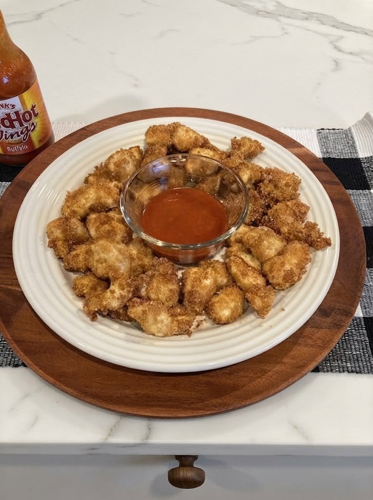 Keto Chicken Nuggets There are certain foods that instantly bring back memories of easy family dinners, and chicken nuggets are definitely one of them. I wanted to make a version that still had that golden, crispy coating and juicy chicken inside—but without the traditional breadcrumbs. After a little experimenting, these Keto Chicken Nuggets became one of those recipes that everyone seems to reach for before the plate even makes it to the table. The secret is a simple combination of almond flour and Parmesan. The almond flour gives the coating that classic crunchy texture, while Parmesan adds a savory, cheesy flavor that makes these nuggets surprisingly addictive. I love making a batch on busy evenings because they come together quickly, and they're just as good for lunchboxes, meal prep, game-day snacking, or a relaxed weekend dinner. And the best part? You don't need to deep-fry them. ❤️ Why You'll Love These Keto Chicken Nuggets Crispy and golden without breadcrumbs Tender and juicy chicken inside Made with simple keto-friendly ingredients Oven-baked or air-fried Family-friendly and easy to customize Great for meal prep Ready in about 30–35 minutes Perfect with your favorite low-carb dipping sauce 🛒 Ingredients You'll Need For the Chicken Nuggets 1 pound boneless, skinless chicken breasts 2 large eggs 1 cup finely ground almond flour 1/2 cup finely grated Parmesan cheese 1 teaspoon garlic powder 1 teaspoon onion powder 1 teaspoon paprika 1/2 teaspoon Italian seasoning 1/2 teaspoon salt 1/4 teaspoon black pepper 1–2 tablespoons olive oil or avocado oil spray For a little extra heat, add a pinch of cayenne pepper. 🍗 How to Make Keto Chicken Nuggets Step 1: Prepare the Chicken Preheat your oven to 400°F (200°C) and line a baking sheet with parchment paper. Cut the chicken breasts into small, nugget-sized pieces. Try to keep the pieces relatively similar in size so they cook evenly. Pat the chicken dry with paper towels. This small step is worth doing because excess moisture can make the coating less crisp. Step 2: Prepare the Egg Wash Crack the eggs into a shallow bowl and whisk until smooth. Set aside. Step 3: Make the Keto Coating In another shallow bowl, combine: Almond flour Parmesan Garlic powder Onion powder Paprika Italian seasoning Salt Black pepper Mix everything thoroughly. The Parmesan is especially helpful here because it adds both flavor and browning to the coating. Almond flour is also commonly used as a low-carb alternative to traditional breading. Step 4: Coat the Chicken Take one piece of chicken and dip it into the beaten egg. Let the excess egg drip off, then place it into the almond-flour mixture. Press the coating gently onto the chicken so it sticks. Transfer the coated nugget to your prepared baking sheet. Repeat with the remaining chicken. Don't overcrowd the pan. Leave a little space between the nuggets so hot air can circulate around them. Step 5: Add a Little Oil Lightly spray or brush the tops of the nuggets with olive or avocado oil. This helps the coating become beautifully golden and crisp in the oven. Step 6: Bake Place the baking sheet in the oven and bake for approximately 10–12 minutes. Carefully flip the nuggets, then continue baking for another 8–12 minutes, depending on their size. The chicken should reach an internal temperature of 165°F (74°C). The exact cooking time can vary depending on how large you cut the chicken, so use temperature rather than color alone to determine doneness. Step 7: Let Them Rest Remove the nuggets from the oven and let them rest for about 3–5 minutes. This gives the chicken a chance to settle while the coating stays crisp. Then grab your favorite dipping sauce and dig in. 🔥 Air Fryer Keto Chicken Nuggets If you want especially crispy nuggets, the air fryer is a fantastic option. Preheat your air fryer to 375°F (190°C). Arrange the coated nuggets in a single layer, leaving space between them. Lightly spray the tops with oil and cook for approximately 10 minutes, flipping halfway through. Check that the chicken reaches 165°F before serving. Air-fryer versions of keto chicken nuggets are commonly cooked around this temperature and finished in roughly 10 minutes, depending on nugget size and the appliance. 🍳 Can You Pan-Fry Them? Absolutely. For an extra-crispy version, heat a thin layer of avocado oil in a skillet over medium heat. Add the coated chicken pieces without overcrowding the pan. Cook for approximately 3–4 minutes per side, or until golden brown and cooked through. Transfer them to a paper towel-lined plate or wire rack. Just be careful not to use excessively high heat—the Parmesan can brown quickly. ⭐ Tips for the Crispiest Keto Nuggets Cut the chicken evenly Small, evenly sized pieces cook much more consistently. Don't skip the Parmesan It adds a wonderful savory flavor and helps the coating brown beautifully. Press the coating on Instead of simply tossing the chicken in the breading, gently press the mixture onto each piece. Don't overcrowd the baking sheet Crowding traps moisture and can prevent the nuggets from becoming crisp. Use a wire rack For an even crispier baked result, place a wire rack over your baking sheet and arrange the nuggets on top. Hot air can circulate underneath as they cook. Let them cook undisturbed If the coating seems delicate when you first flip the nuggets, use a thin spatula and turn them carefully. 🌶️ Easy Flavor Variations Spicy Keto Nuggets Add 1/4–1/2 teaspoon cayenne pepper to the coating. Ranch Nuggets Add 1 tablespoon of your favorite keto-friendly ranch seasoning to the almond flour mixture. Garlic Parmesan Nuggets Increase the garlic powder slightly and add an extra tablespoon of Parmesan. Bacon Parmesan Nuggets Finely crumble a few cooked bacon slices and mix them into the coating. Bacon-Parmesan versions are another popular low-carb variation. Buffalo Chicken Nuggets Serve the finished nuggets with a little buffalo sauce and ranch dressing. 🥣 Best Dipping Sauces A great dipping sauce takes these nuggets from good to seriously crave-worthy. Try: Sugar-free ketchup Ranch dressing Garlic aioli Buffalo sauce Spicy mayonnaise Dijon mustard Avocado-lime dip Low-carb honey mustard For a simple homemade sauce, mix 1/4 cup mayonnaise, 1 tablespoon Dijon mustard, 1 tablespoon sugar-free ketchup, and a pinch of garlic powder. That's it. 🥗 What to Serve with Keto Chicken Nuggets These nuggets are filling enough to serve as a complete meal, especially when paired with a vegetable side. Try them with: Crispy zucchini fries Cauliflower tots Roasted broccoli Air-fried Brussels sprouts Cucumber salad Coleslaw Avocado salad Cauliflower mash A simple green salad For a quick dinner, I love putting a pile of nuggets in the middle of the table with several dipping sauces and a big bowl of crunchy salad. Everyone can grab what they want, and there's hardly any fuss. 👨👩👧👦 Perfect for Family Dinner One of my favorite things about homemade nuggets is that they don't feel like "diet food." They're crispy, cheesy, savory, and familiar. That's especially helpful when you're cooking for a family and don't want to prepare completely different meals for everyone. Put out a few dipping sauces and let everyone choose their favorite. These are also great for a casual Friday night when you want something fun without ordering takeout. 🧊 How to Store Leftovers Allow the nuggets to cool completely before storing. Place them in an airtight container and refrigerate for up to 4 days. For the best texture, don't microwave them if you can avoid it. Microwaving tends to soften the coating. Instead, reheat them in: Air fryer: 375°F for 3–5 minutes Oven: 375°F for about 8–10 minutes They should be hot throughout before serving. ❄️ Can You Freeze Keto Chicken Nuggets? Yes! These nuggets are excellent for meal prep. Let the cooked nuggets cool completely, then arrange them on a baking sheet in a single layer and freeze until solid. Transfer them to a freezer-safe container or bag. For best quality, use within about 2–3 months. Reheat directly from frozen in an air fryer or oven until hot and crispy. Freezing and batch-prepping chicken nuggets is also recommended by several keto recipe sources because they make an easy grab-and-reheat meal. ❓ Frequently Asked Questions Are chicken nuggets keto? Traditional chicken nuggets usually contain wheat-based breadcrumbs, so they aren't typically suitable for a strict keto diet. This version replaces traditional breading with almond flour and Parmesan, keeping the recipe much lower in carbohydrates. Can I use chicken thighs? Absolutely. Boneless, skinless chicken thighs will give you particularly juicy nuggets. Cut them into evenly sized pieces and cook until they reach 165°F. Can I use coconut flour instead of almond flour? You can, but don't substitute it cup-for-cup. Coconut flour absorbs significantly more moisture than almond flour, so the coating needs to be reformulated. For this recipe, almond flour gives the most reliable texture. Can I use pork rinds? Yes. Finely crushed pork rinds can replace some or all of the almond flour if you prefer a very crunchy coating. Why isn't my coating crispy? Usually, excess moisture or overcrowding is the culprit. Pat the chicken dry, don't overcrowd the pan, and lightly spray the coating with oil before baking. An air fryer can also give you a crispier finish. Can I make these ahead? Yes. You can coat the chicken several hours ahead and refrigerate it until you're ready to cook. For the crispiest results, don't leave the raw coated chicken refrigerated for too long because the coating can absorb moisture. 📝 Recipe at a Glance Prep Time: 15 minutes Cook Time: 18–24 minutes Total Time: About 30–35 minutes Servings: 4 Ingredients 1 lb boneless, skinless chicken breasts 2 large eggs 1 cup almond flour 1/2 cup grated Parmesan 1 tsp garlic powder 1 tsp onion powder 1 tsp paprika 1/2 tsp Italian seasoning 1/2 tsp salt 1/4 tsp black pepper 1–2 tbsp olive or avocado oil Instructions Preheat oven to 400°F. Cut chicken into evenly sized nugget pieces. Whisk eggs in a shallow bowl. Combine almond flour, Parmesan, and seasonings in another bowl. Dip chicken into egg, then coat thoroughly in the almond-flour mixture. Place on a lined baking sheet. Lightly spray with oil. Bake for 10–12 minutes. Flip and bake another 8–12 minutes. Check that the chicken reaches 165°F. Rest for 3–5 minutes. Serve hot with your favorite keto-friendly dipping sauce. ❤️ Final Thoughts These Keto Chicken Nuggets are one of those recipes that prove eating low-carb doesn't mean giving up the foods you love. They're crispy on the outside, tender inside, and packed with that savory Parmesan flavor that makes you want to reach for just one more. I especially love serving them family-style with three or four dipping sauces in the middle of the table. It turns a simple chicken dinner into something everyone gets excited about. Whether you're making them for a busy weeknight, meal prepping for the week, or simply craving something crispy and comforting, keep this recipe close. Once you have a batch of these golden little nuggets ready to go, takeout chicken nuggets might have a hard time competing.