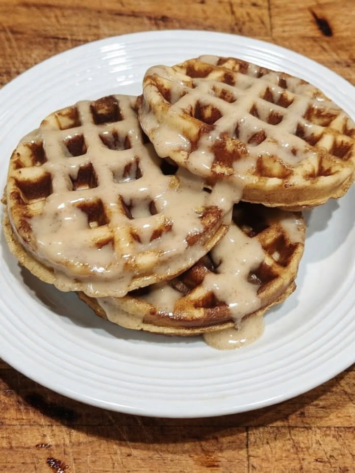 Keto Cinnamon Roll Chaffles There are mornings when I want the smell of cinnamon rolls filling the kitchen, but I definitely don’t want to spend an hour waiting for dough to rise. That’s exactly why these Keto Cinnamon Roll Chaffles have become such a fun little breakfast. They’re warm, buttery, cinnamon-scented, slightly crisp around the edges, and topped with a creamy sugar-free glaze that makes them taste surprisingly close to a cinnamon roll. I especially love making these on slow weekend mornings. They feel like a treat, but they come together in just minutes. And if you’re someone who misses traditional cinnamon rolls while following a keto or low-carb lifestyle, this recipe is definitely worth keeping around. The secret is the combination of mozzarella, almond flour, egg, and cream cheese. The cheese gives the chaffle that familiar waffle texture, while cinnamon and vanilla turn it into something much more dessert-like. A simple cream-cheese glaze on top finishes everything beautifully. ❤️ Why You’ll Love These Keto Cinnamon Roll Chaffles Quick and easy: No yeast, kneading, or rising time. Keto-friendly: Made without traditional wheat flour or sugar. Cinnamon-roll flavor: Warm cinnamon, vanilla, sweetness, and creamy glaze. Perfect for breakfast: They’re satisfying without requiring much prep. Great for meal prep: Cook a batch ahead and reheat when needed. Customizable: Add nuts, extra cinnamon, or a little sugar-free caramel drizzle. 🧇 What Exactly Is a Chaffle? A chaffle is essentially a low-carb waffle made with cheese and eggs. Mozzarella is especially useful in sweet chaffles because it has a mild flavor and melts beautifully. For this cinnamon-roll version, we add almond flour, cinnamon, sweetener, vanilla, and cream cheese to make the flavor softer and sweeter. The result isn't exactly the same as a traditional yeast-based cinnamon roll—but that's part of the charm. You get those cozy cinnamon-roll flavors in a much faster breakfast. 🛒 Ingredients For the Cinnamon Roll Chaffles 3 large eggs 1/4 cup almond flour 3/4 cup shredded mozzarella cheese 2 ounces cream cheese, softened 2 tablespoons granulated keto-friendly sweetener 1 teaspoon ground cinnamon 1/2 teaspoon baking powder 1/2 teaspoon vanilla extract Pinch of salt Nonstick spray or a little melted butter for the waffle maker For the Cream Cheese Glaze 2 ounces cream cheese, softened 1/2 cup powdered keto-friendly sweetener 1/2 teaspoon vanilla extract 2–3 tablespoons heavy cream, as needed Optional Cinnamon Sugar Topping 1 tablespoon granulated keto sweetener 1/2 teaspoon cinnamon The ingredient combination is adapted from several established cinnamon-roll chaffle approaches, which commonly use eggs, almond flour, mozzarella, cinnamon, sweetener, and a cream-cheese-based icing. 👩‍🍳 How to Make Keto Cinnamon Roll Chaffles Step 1: Preheat the waffle maker Preheat your mini waffle maker according to its instructions. Lightly spray it with nonstick cooking spray. This is especially helpful with sweet chaffles because the cream cheese can make the batter a little sticky. Step 2: Mix the wet ingredients In a medium bowl, whisk the eggs until smooth. Add the softened cream cheese and vanilla extract. Whisk until the cream cheese is mostly incorporated. A few tiny cream-cheese specks are completely fine. Step 3: Add the dry ingredients Stir in the almond flour, sweetener, cinnamon, baking powder, and salt. Mix until you have a fairly smooth batter. Step 4: Add the mozzarella Fold in the shredded mozzarella. If your cream cheese is very soft, the cheese should distribute easily throughout the mixture. Step 5: Cook the chaffles Spoon a small portion of batter into the center of your mini waffle maker. Don't overfill it. The batter expands as it cooks, so filling the waffle maker around two-thirds full is a good starting point. Close the lid and cook for approximately 4–6 minutes, or until the chaffle is golden and cooked through. Try not to open the waffle maker too early. If the chaffle is still soft, it may pull apart when you lift the lid. Step 6: Make the glaze While the chaffles cook, beat the softened cream cheese with the powdered sweetener and vanilla. Add the heavy cream, one tablespoon at a time, until the glaze reaches your preferred consistency. For a drizzle, make it fairly thin. For a thick frosting-like topping, use less cream. Step 7: Add the cinnamon topping Mix the granulated sweetener and cinnamon together. Once the chaffles are slightly cooled, drizzle them generously with the cream cheese glaze and sprinkle with the cinnamon mixture. And that's it! You now have a warm, gooey-tasting cinnamon-roll breakfast without waiting for dough to rise. ✨ My Best Tips for Perfect Chaffles Don't overfill your waffle maker This is probably the most important tip. Chaffle batter spreads and puffs as it cooks. A smaller amount gives you much better control and helps prevent batter from escaping around the edges. Let them cook long enough Sweet chaffles can be a little delicate while they're hot. Give them enough time to become golden and firm before removing them. Use finely shredded mozzarella Freshly shredded mozzarella melts nicely and tends to blend into the batter better than large, chunky shreds. Soften your cream cheese Soft cream cheese mixes much more easily. If it's straight from the refrigerator, you'll have a harder time getting a smooth batter and glaze. Don't skip the glaze The cinnamon chaffle itself is delicious, but the cream-cheese glaze is what really gives it that cinnamon-roll feeling. 🥜 Delicious Variations Pecan Cinnamon Roll Chaffles Fold a tablespoon or two of finely chopped pecans into the batter or sprinkle them over the glaze. Extra Cinnamon If you're a serious cinnamon lover, increase the cinnamon in the batter to 1 1/2 teaspoons. Cinnamon Butter Chaffles Spread a little softened butter over the warm chaffle before adding the glaze. Maple Cinnamon Add a few drops of sugar-free maple extract to the cream-cheese glaze. Chocolate Cinnamon Add a small handful of sugar-free chocolate chips to the batter for a cinnamon-chocolate combination. Coconut Flour Version If you'd rather use coconut flour, don't substitute it cup-for-cup for almond flour. Coconut flour absorbs significantly more liquid, so the recipe needs to be reformulated rather than simply swapping equal amounts. 🍓 What to Serve With Cinnamon Roll Chaffles These are delicious on their own, but you can turn them into a complete breakfast with: Scrambled or fried eggs Crispy bacon Breakfast sausage Sugar-free whipped cream A few fresh berries Chopped pecans or walnuts Butter Sugar-free maple syrup For a weekend brunch, I love serving them with crispy bacon and a cup of hot coffee. That combination really gives you the cozy breakfast feeling of traditional cinnamon rolls. 🧊 Can You Make These Ahead? Absolutely. Cook the chaffles according to the recipe and let them cool completely. Store them in an airtight container in the refrigerator for up to 4 days. For longer storage, place parchment paper between the chaffles and freeze them in a freezer-safe bag or container. The chaffles can be reheated in a toaster, toaster oven, or air fryer until warmed through and slightly crisp. For the best texture, keep the cream-cheese glaze separate and add it after reheating. 🔥 How to Make Them Extra Crispy If you prefer a crispier chaffle, cook it a little longer in the waffle maker. You can also place the cooked chaffle in an air fryer or toaster oven for a couple of minutes after cooking. Letting it cool for a minute before adding the glaze also helps the outside stay pleasantly crisp instead of becoming soft immediately. ❓ Frequently Asked Questions Are cinnamon roll chaffles keto? They can fit a keto or low-carb diet when made with low-carb ingredients and a suitable keto sweetener. The exact carbohydrate count depends on the specific brands and quantities you use. Do cinnamon chaffles taste like cheese? Not strongly. Mozzarella has a mild flavor, and the cinnamon, vanilla, sweetener, and cream-cheese glaze do most of the flavor work. Can I use cheddar instead of mozzarella? You can, but I wouldn't recommend it for this particular recipe. Cheddar has a much stronger flavor and can make a sweet chaffle taste noticeably cheesy. Can I make these without almond flour? Yes, but you'll need a different flour ratio. Coconut flour absorbs much more moisture than almond flour, so it isn't a straight one-to-one substitution. Why is my chaffle sticking? Usually it's because the waffle maker wasn't sufficiently preheated, there wasn't enough nonstick spray, or the chaffle was removed before it had finished cooking. Why did my chaffle fall apart? It may simply need more cooking time. Let it cook until the surface is golden and firm before carefully removing it. Can I freeze cinnamon roll chaffles? Yes. Cool them completely, separate them with parchment paper, and freeze in an airtight container or freezer bag. Reheat directly from frozen. Can I make the cream-cheese glaze ahead? Yes. Store the glaze covered in the refrigerator for several days. Let it soften slightly and stir before drizzling over warm chaffles. 📝 Recipe at a Glance Recipe: Keto Cinnamon Roll Chaffles Prep Time: 10 minutes Cook Time: 10 minutes Total Time: About 20 minutes Yield: Approximately 6 mini chaffles Course: Breakfast Cuisine: Keto / American-inspired Ingredients Chaffles 3 eggs 1/4 cup almond flour 3/4 cup mozzarella 2 oz cream cheese 2 tbsp keto sweetener 1 tsp cinnamon 1/2 tsp baking powder 1/2 tsp vanilla Pinch of salt Glaze 2 oz cream cheese 1/2 cup powdered keto sweetener 1/2 tsp vanilla 2–3 tbsp heavy cream Instructions Preheat a mini waffle maker and lightly grease it. Whisk eggs, softened cream cheese, and vanilla. Mix in almond flour, sweetener, cinnamon, baking powder, and salt. Fold in mozzarella. Add a small amount of batter to the waffle maker. Cook for 4–6 minutes, or until golden and cooked through. Beat together the cream cheese, powdered sweetener, vanilla, and heavy cream to make the glaze. Drizzle glaze over warm chaffles. Finish with a sprinkle of cinnamon and keto sweetener if desired. Serve warm. ❤️ Final Thoughts These Keto Cinnamon Roll Chaffles are one of those recipes that make a low-carb breakfast feel anything but boring. They have that warm cinnamon aroma, a tender waffle-like center, lightly crisp edges, and that sweet-tangy cream-cheese glaze that makes you want to lick the plate afterward. And perhaps my favorite part is how little effort they require. When the craving for cinnamon rolls hits, you don't have to wait for dough to rise or spend the morning in the kitchen. Just mix, waffle, glaze, and enjoy. Sometimes that's exactly what a weekend breakfast needs.