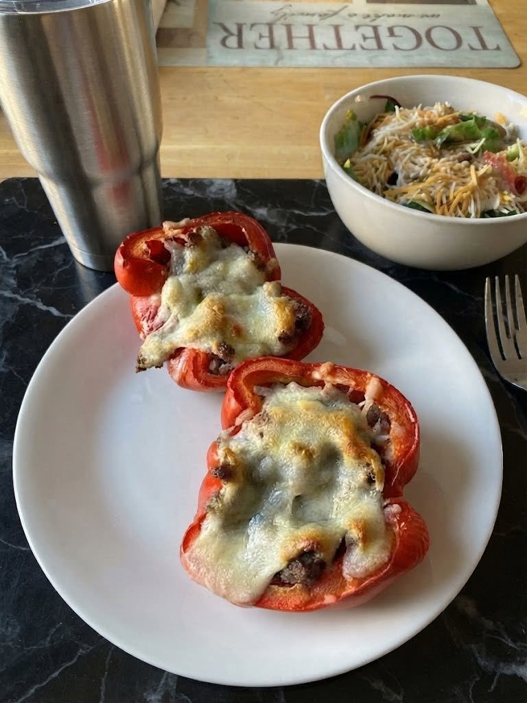 🫑 Keto Stuffed Peppers With Ground Sausage and Cheese There are some dinners that just feel like home, and these Keto Stuffed Peppers With Ground Sausage and Cheese are definitely one of them. I first made these on a weekend when I wanted something comforting and cheesy without spending hours in the kitchen. I had some ground sausage in the refrigerator, a few bell peppers waiting to be used, and, of course, plenty of cheese. That combination turned into one of those dinners that disappears from the table surprisingly fast. The sausage gives the filling so much flavor that you don't need a complicated list of ingredients. The peppers become tender and slightly sweet as they bake, while the cheese melts over the top into that golden, bubbly layer we all love. And the best part? There's no rice or breadcrumbs hiding in the filling. Just flavorful sausage, vegetables, seasonings, and lots of cheesy goodness. ❤️ Why You'll Love These Keto Stuffed Peppers Low-carb and satisfying: No rice, pasta, or breadcrumbs. Packed with flavor: Italian-style sausage does most of the heavy lifting. Extra cheesy: Cheese goes both inside and on top. Easy weeknight dinner: Most of the work happens in one skillet. Family-friendly: Even people who aren't following keto usually love these. Great for leftovers: They reheat beautifully for lunch the next day. Stuffed peppers are wonderfully flexible, too. You can change the meat, cheese, seasonings, or vegetables depending on what's in your refrigerator. 🛒 Ingredients You'll Need For the Peppers 4 large bell peppers 1 tablespoon olive oil For the Sausage Filling 1 pound ground Italian sausage 1/2 small yellow onion, finely diced 2 cloves garlic, minced 1/2 cup sugar-free tomato sauce 1 teaspoon Italian seasoning 1/2 teaspoon smoked paprika 1/2 teaspoon salt 1/4 teaspoon black pepper 1 cup shredded mozzarella cheese 1/2 cup shredded cheddar cheese For the Topping 1/2 cup additional shredded mozzarella cheese 2 tablespoons grated Parmesan cheese Fresh parsley, optional Tip: If you're keeping the recipe strictly keto, check your sausage and tomato sauce labels for added sugar or starch. Some sausage products can contain hidden carbohydrates. 👩🍳 How to Make Keto Stuffed Peppers 1. Prepare the Peppers Preheat your oven to 375°F (190°C). Wash the bell peppers and cut them in half lengthwise. Remove the seeds and white membranes. Place the pepper halves cut-side up in a lightly greased baking dish. If your peppers are especially large and firm, you can pre-bake them for about 8–10 minutes before adding the filling. This gives them a head start and makes the finished peppers extra tender. 2. Brown the Sausage Heat the olive oil in a large skillet over medium heat. Add the ground Italian sausage and cook for about 5–7 minutes, breaking it apart with a wooden spoon as it browns. If there's a lot of excess grease, carefully drain some of it. 3. Add the Onion and Garlic Add the diced onion to the skillet. Cook for 3–4 minutes, until the onion begins to soften. Add the minced garlic and cook for another 30–60 seconds, just until fragrant. This little step makes such a difference. The garlic and sausage together create that irresistible savory smell that makes everyone start wandering into the kitchen asking, "What's for dinner?" 4. Season the Filling Stir in the tomato sauce, Italian seasoning, smoked paprika, salt, and black pepper. Let everything simmer together for about 3–4 minutes. Taste the mixture and adjust the seasoning if needed. 5. Make It Cheesy Remove the skillet from the heat. Stir in 1 cup mozzarella and 1/2 cup cheddar until the cheese starts melting into the sausage mixture. The filling should be thick, creamy, savory, and easy to spoon into the peppers. 6. Stuff the Peppers Spoon the sausage mixture evenly into each pepper half. Don't be afraid to pile the filling up slightly. As the cheese melts, everything settles into the peppers. Sprinkle the remaining mozzarella and Parmesan over the tops. 7. Bake Cover the baking dish loosely with aluminum foil and bake for 20 minutes. Remove the foil and continue baking for another 10–15 minutes, until the peppers are tender and the cheese is melted, bubbling, and lightly golden. For an extra-browned cheese topping, place the peppers under the broiler for 1–2 minutes at the end. Watch them carefully because cheese can go from golden to burnt very quickly. Let the peppers rest for about 5 minutes before serving. 🧀 The Best Cheese for Stuffed Peppers Mozzarella is my favorite here because it melts beautifully, but you have plenty of options. Try: Cheddar for a stronger, richer flavor Monterey Jack for an ultra-creamy melt Provolone for an Italian-inspired flavor Gouda for something slightly smoky Parmesan for a salty golden crust Colby Jack for a mild, family-friendly option A combination of mozzarella and cheddar is hard to beat. 🌶️ Easy Variations Spicy Sausage Stuffed Peppers Use hot Italian sausage and add a pinch of crushed red pepper flakes. Creamy Sausage Peppers Stir 2–3 tablespoons of softened cream cheese into the cooked sausage mixture before stuffing the peppers. Pizza-Style Stuffed Peppers Add a little extra sugar-free marinara, mozzarella, Italian seasoning, and chopped pepperoni. Bacon Cheeseburger Version Swap the Italian sausage for ground beef and add cooked bacon, cheddar, mustard, and a little onion. Mushroom & Sausage Sauté 1 cup sliced mushrooms with the onions before adding the sausage. Green Pepper Version Use green bell peppers if you prefer a slightly less sweet, more savory flavor. 🥗 What to Serve With Keto Stuffed Peppers These peppers are filling enough to serve as a complete meal, but I love adding a simple side. Try them with: Garlic butter broccoli Roasted cauliflower Sautéed spinach Cauliflower rice Simple green salad Cucumber salad Steamed green beans Garlic mushrooms Avocado salad If I'm making these on a busy weeknight, a quick green salad is usually all I need. 💡 Tips for Perfect Stuffed Peppers Choose peppers that stand up well. Look for large peppers with relatively flat bottoms. If you're using whole peppers rather than halves, trim just a tiny bit from the bottom if necessary so they stand upright. Don't overcook the sausage. Brown it until cooked through, but don't let it become dry before it goes into the oven. Don't skip the cheese inside. Adding cheese directly to the filling helps bind everything together and makes every bite creamy. Use freshly shredded cheese when possible. It usually melts more smoothly than many pre-shredded varieties. Don't over-bake the peppers. You want them tender but still sturdy enough to hold the filling. Let them rest. Five minutes gives the filling time to settle, which makes the peppers easier to serve. 🥘 Can I Make These Ahead? Absolutely. Prepare the sausage filling, stuff the peppers, cover the baking dish, and refrigerate for up to 24 hours. When you're ready to cook them, take the dish out of the refrigerator while the oven preheats. You may need to add a few extra minutes to the baking time because the peppers and filling will be cold. 🧊 How to Store Leftovers Store leftover stuffed peppers in an airtight container in the refrigerator for up to 3–4 days. For the best texture, reheat them in the oven or air fryer rather than microwaving them for too long. Oven Reheat at 350°F (175°C) for about 10–15 minutes, or until hot. Air Fryer Heat at 350°F for approximately 5–8 minutes. Microwave Microwave individual portions for 1–2 minutes, checking halfway through. ❄️ Can You Freeze Stuffed Peppers? Yes. Let the cooked peppers cool completely, then place them in an airtight freezer-safe container. Freeze for up to 2–3 months for the best quality. Thaw overnight in the refrigerator and reheat at 350°F until heated through. For the best texture, I prefer freezing the assembled but uncooked peppers when possible, then thawing them in the refrigerator before baking. ❓ Frequently Asked Questions Are stuffed peppers keto? They can be. The main thing is what you put inside them. Traditional stuffed peppers often contain rice or other higher-carb ingredients, while this version uses sausage, cheese, and a sugar-free tomato sauce instead. Similar keto versions use meat, cheese, and peppers without rice. Can I use ground beef instead of sausage? Absolutely. Ground beef works beautifully. You may want to add extra Italian seasoning, garlic, and fennel seed to give it some of the flavor that sausage naturally provides. Can I use ground turkey? Yes. Ground turkey is leaner, so consider adding a little extra cheese or cream cheese to keep the filling moist. Do I need to boil the peppers first? No. You can bake them directly after stuffing. If you prefer very soft peppers, pre-bake the halves for 8–10 minutes before filling them. Can I use whole peppers instead of halves? Yes. Cut off the tops, remove the seeds and membranes, then stand the peppers upright in a baking dish. They may need a little extra baking time. What sausage is best? Mild or hot Italian sausage works especially well. Breakfast sausage can also work if you prefer a more savory breakfast-style flavor. Always check the label if you're following keto, because some prepared sausages contain added sugars or starches. Can I make these without tomato sauce? Yes. Simply leave it out and replace it with a few tablespoons of chicken broth or heavy cream. You can also make a creamy cheese-based filling with cream cheese. How do I prevent watery stuffed peppers? Don't add too much sauce, and make sure the sausage filling isn't excessively greasy. Letting the peppers rest for a few minutes after baking also helps the filling set. 📝 Recipe at a Glance Recipe: Keto Stuffed Peppers With Ground Sausage and Cheese Prep Time: 15 minutes Cook Time: 30–35 minutes Total Time: About 50 minutes Servings: 4 Cuisine: American / Italian-inspired Diet: Keto / Low Carb 🌟 Final Thoughts These Keto Stuffed Peppers With Ground Sausage and Cheese are exactly the kind of recipe I love having in my back pocket. They're cozy without being complicated, cheesy without needing a dozen ingredients, and filling enough to make everyone happy around the dinner table. I especially love making them on weekends when I want something that feels a little special but still feels like easy home cooking. There's something about pulling that bubbling dish of golden, cheesy peppers out of the oven that makes dinner feel instantly comforting. And when everyone is scraping the last bit of sausage and melted cheese from the baking dish, you know you've found a keeper. Sometimes the simplest dinners really are the ones we remember.