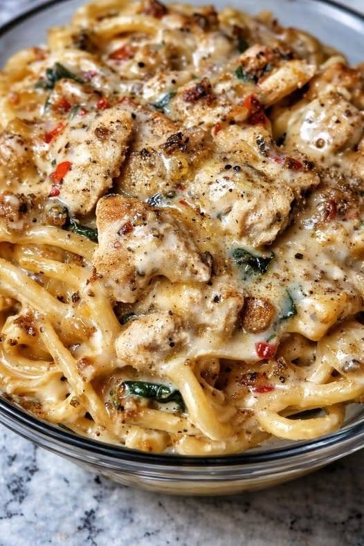 🍝 Creamy Cream Cheese Chicken Linguine with Spinach There are nights when I want a dinner that feels a little special but still comes together without making a huge production out of it. This Creamy Cream Cheese Chicken Linguine with Spinach is exactly that kind of meal. It's creamy, garlicky, cheesy, comforting, and loaded with tender pieces of seasoned chicken and fresh spinach. And the best part? The sauce comes together with cream cheese and a little reserved pasta water, so you don't need a complicated cream sauce or a long list of ingredients. I first made this on a weekend when I wanted something cozy for the family but didn't want to spend the whole afternoon in the kitchen. I had chicken in the refrigerator, a package of linguine in the pantry, and some spinach that needed to be used. Cream cheese was sitting in the fridge too. So I decided to put everything together. That first bite was the moment I knew this was going to become one of those recipes I made again and again. The chicken was golden and juicy, the linguine was coated in a velvety sauce, and the spinach added just enough freshness to balance all that creamy richness. Everyone loved it. And honestly, I loved how easy the whole dinner was. ❤️ Why You'll Love This Chicken Linguine This is the kind of recipe that checks almost every box for a busy family dinner. 🍗 Tender, flavorful chicken 🧀 Rich cream cheese sauce 🥬 Fresh spinach 🍝 Perfectly silky linguine 🧄 Plenty of garlicky flavor 🧀 Parmesan for extra savory richness ⏱️ Ready in about 30–35 minutes 🍽️ Great for weeknights or weekends 👨‍👩‍👧‍👦 Family-friendly and comforting 🥣 Delicious leftovers Cream cheese works particularly well in pasta sauces because it melts into the cooking liquid and helps create a thick, creamy texture. Similar chicken-spinach pasta recipes combine cream cheese with Parmesan and pasta water or chicken broth for a smooth sauce. 🛒 Ingredients You'll Need For the Chicken 1½ pounds boneless, skinless chicken breasts Cut into bite-sized pieces. You can also use boneless chicken thighs if you prefer darker meat. 1 tablespoon olive oil For searing the chicken. 1 teaspoon Italian seasoning ½ teaspoon garlic powder ½ teaspoon paprika ¾ teaspoon salt ½ teaspoon black pepper The seasoning is simple, but it gives the chicken a lovely savory crust. For the Creamy Spinach Sauce 12 ounces linguine Regular linguine works beautifully, but whole-wheat or another pasta shape can also be used. 4 ounces cream cheese Use softened cream cheese if possible. It melts much more easily into the sauce. ½ cup freshly grated Parmesan cheese Freshly grated Parmesan melts more smoothly than many pre-shredded varieties. 3 cloves garlic, minced Because creamy pasta without garlic just doesn't feel quite right to me. 2 tablespoons butter For sautéing the garlic and enriching the sauce. ½ cup low-sodium chicken broth This helps loosen the cream cheese into a silky sauce. 3–4 cups fresh baby spinach It may look like far too much when you first add it, but spinach cooks down dramatically. ½–1 cup reserved pasta water You may not need all of it. ¼ teaspoon red pepper flakes, optional I love a tiny bit of heat in this dish. 1 tablespoon fresh lemon juice Optional, but highly recommended. It brightens the rich sauce beautifully. 👩‍🍳 How to Make Creamy Cream Cheese Chicken Linguine Step 1: Cook the Linguine Bring a large pot of generously salted water to a boil. Cook the linguine according to the package directions until al dente. Before draining, scoop out at least 1 cup of the pasta water. Don't skip this. That starchy water is one of the easiest ways to loosen the cream cheese sauce while helping it cling to the noodles. Creamy spinach pasta recipes commonly reserve pasta water specifically for this purpose. Drain the linguine and set it aside. 🍗 Step 2: Season the Chicken Place the chicken pieces in a bowl. Add the Italian seasoning, garlic powder, paprika, salt, and black pepper. Toss everything together until the chicken is evenly coated. I like cutting the chicken into fairly small, bite-sized pieces because you get a little bit of chicken in almost every forkful of pasta. 🔥 Step 3: Cook the Chicken Heat the olive oil in a large skillet over medium-high heat. Add the chicken in a single layer. Cook for about 3–4 minutes, then turn the pieces and cook another 3–4 minutes, or until golden on the outside and cooked through. The chicken should reach 165°F (74°C) in the thickest pieces. Transfer the cooked chicken to a plate. Don't wipe out the skillet. Those little browned bits on the bottom are flavor gold. 🧄 Step 4: Sauté the Garlic Reduce the heat to medium. Add the butter to the same skillet. Once melted, add the minced garlic. Cook for about 30–60 seconds, stirring constantly. You want the garlic fragrant, but don't let it turn dark brown. Burned garlic will make the entire sauce taste bitter. 🧀 Step 5: Make the Cream Cheese Sauce Pour in the chicken broth. Use a wooden spoon to scrape up the browned bits from the bottom of the skillet. Add the softened cream cheese. Stir continuously over medium-low heat until the cream cheese melts into the broth. At first, the mixture may look slightly lumpy. Keep stirring. It will gradually become smooth and creamy. Add the Parmesan and stir until melted. If the sauce looks too thick, add a splash of reserved pasta water. This is where you get to control the consistency. I like my sauce creamy enough to coat the linguine but loose enough that the pasta doesn't feel heavy. 🥬 Step 6: Add the Spinach Add the fresh spinach directly to the sauce. It will look like an enormous pile at first. Don't worry. Give it a minute or two and it will wilt down into the sauce. Stir until the spinach is tender and evenly distributed. Add the red pepper flakes if you're using them. 🍝 Step 7: Add the Linguine Add the cooked linguine to the skillet. Toss everything together gently. Add reserved pasta water a little at a time until the sauce reaches the consistency you like. I usually start with ¼ cup and add more as needed. The noodles will absorb some of the sauce as they sit, so it's better to keep the sauce slightly looser than you think you need. 🍗 Step 8: Return the Chicken Add the cooked chicken back to the skillet. Toss gently until everything is coated in that creamy garlic-Parmesan sauce. Cook for another 1–2 minutes, just until everything is hot. Turn off the heat. Add the lemon juice and give everything one final toss. Taste and adjust the salt and pepper. ✨ The Secret to a Silky Cream Cheese Sauce The biggest mistake with cream cheese pasta is turning the heat up too high. You don't need aggressive heat. Once the cream cheese goes into the skillet, keep the temperature around medium-low and stir patiently. If the sauce becomes too thick, add pasta water. If it becomes too thin, let it gently simmer for a minute or two while stirring. The goal is a sauce that's: Creamy + glossy + smooth + thick enough to coat the pasta. Not stiff. Not watery. And definitely not grainy. 🍽️ What to Serve With Chicken Linguine This pasta is filling enough to be a complete meal, but I always like having something fresh on the side. 🥖 Garlic Bread Obviously. You need something to scoop up that extra cream sauce. 🥗 Simple Green Salad A crisp salad with lemon vinaigrette provides a nice contrast to the rich pasta. 🥦 Roasted Broccoli The slightly charred edges of roasted broccoli taste fantastic with the creamy sauce. 🍅 Tomato Salad Fresh tomatoes with basil and a little olive oil can add a bright, fresh element. 🥬 Steamed Green Beans Simple, fresh, and easy. 💡 My Best Tips for Perfect Creamy Chicken Linguine Use softened cream cheese Cold cream cheese takes longer to melt and can leave little lumps in the sauce. Let it sit at room temperature for about 15–20 minutes before cooking if possible. Don't boil the sauce aggressively Gentle heat is your friend. Once the cream cheese and Parmesan are incorporated, avoid a hard boil. Save more pasta water than you think you'll need You can always throw the extra away. But once the pasta is drained, you can't get that starchy water back. Don't overcook the spinach You only need to wilt it. Overcooked spinach can lose its fresh flavor and turn dull. Cook the chicken separately first Searing the chicken gives it a beautiful browned exterior and leaves flavorful bits in the skillet for the sauce. Grate Parmesan yourself if possible Fresh Parmesan melts beautifully into the warm sauce. 🥬 Fresh or Frozen Spinach? Both work. Fresh spinach This is my first choice. Use about 3–4 cups, depending on how spinach-heavy you want the pasta. Frozen spinach You can absolutely use frozen spinach. Thaw it completely and squeeze out as much excess water as possible before adding it to the sauce. Otherwise, the extra moisture can thin the sauce. 🍗 Easy Variations Creamy Tuscan Chicken Linguine Add chopped sun-dried tomatoes. They bring a slightly sweet, tangy flavor that works beautifully with the cream cheese sauce. Mushroom Chicken Linguine Sauté 8 ounces of sliced mushrooms after cooking the chicken. Then continue with the sauce. Spicy Chicken Linguine Add extra red pepper flakes or a pinch of cayenne. Broccoli Chicken Linguine Add small steamed broccoli florets toward the end. Lemon Garlic Chicken Linguine Increase the lemon juice slightly and add a little lemon zest. This is especially good when you want something that tastes a little lighter. Extra Cheesy Add another ¼ cup of Parmesan. You can also stir in a little shredded mozzarella for an extra-melty sauce. 🥄 Can I Make This Without Heavy Cream? Absolutely. That's actually one of the things I like about this recipe. The cream cheese provides plenty of richness on its own, while chicken broth and reserved pasta water help create the sauce. You don't necessarily need heavy cream. A similar cream-cheese chicken pasta approach uses cream cheese with chicken broth or reserved pasta water rather than relying entirely on heavy cream. 🧊 How to Store Leftovers Store leftover pasta in an airtight container in the refrigerator for up to 3–4 days. The sauce will thicken as it chills. That's completely normal. When reheating, add a splash of: Chicken broth Milk Water Or reserved pasta water if you happened to save some Reheat gently over low heat or in the microwave in short intervals. Stir frequently. This helps bring the sauce back to that creamy consistency. ❄️ Can You Freeze Cream Cheese Chicken Linguine? You can, but I don't recommend it if you want the very best texture. Cream-based sauces can sometimes separate slightly after freezing and thawing, and pasta can become softer. If you do freeze it, cool it completely first and store it in a freezer-safe container. Thaw overnight in the refrigerator and reheat gently. For the freshest texture, I prefer making the sauce fresh. ❓ Frequently Asked Questions Can I use chicken thighs? Yes. Boneless, skinless chicken thighs are delicious here and tend to be especially juicy. Can I use another pasta shape? Absolutely. Fettuccine, spaghetti, penne, rigatoni, or farfalle can all work. Linguine is my favorite because its flat shape holds onto the creamy sauce beautifully. Can I use low-fat cream cheese? Yes, although full-fat cream cheese generally gives you a richer and smoother sauce. Why is my sauce too thick? Add reserved pasta water a tablespoon or two at a time. The starch helps loosen the sauce without making it watery. Why is my sauce grainy? The heat may have been too high, especially after adding the cheese. Reduce the heat and add a small splash of warm pasta water while stirring. Can I add mushrooms? Definitely. Sliced mushrooms are one of my favorite additions. Cook them until browned before making the sauce. Can I use frozen spinach? Yes. Just thaw and squeeze it very dry before adding it. Can I make this ahead? You can cook the chicken and prepare the sauce ahead of time, but I recommend cooking the linguine close to serving time. Freshly cooked pasta gives you the best texture. Is this recipe spicy? Not as written. The red pepper flakes are optional, so you can leave them out completely for a mild, family-friendly version. 📋 Creamy Cream Cheese Chicken Linguine at a Glance Prep Time: 10 minutes Cook Time: 20–25 minutes Total Time: About 30–35 minutes Servings: 4–6 Difficulty: Easy Ingredients 1½ pounds boneless, skinless chicken breasts 12 ounces linguine 4 ounces cream cheese ½ cup Parmesan cheese 3–4 cups fresh baby spinach 3 cloves garlic ½ cup low-sodium chicken broth 2 tablespoons butter 1 tablespoon olive oil 1 teaspoon Italian seasoning ½ teaspoon garlic powder ½ teaspoon paprika ¾ teaspoon salt ½ teaspoon black pepper ½–1 cup reserved pasta water ¼ teaspoon red pepper flakes, optional 1 tablespoon lemon juice, optional Quick Method Cook linguine and reserve pasta water. Season and sear the chicken until cooked through. Remove chicken and sauté garlic in butter. Add broth and cream cheese. Stir in Parmesan until smooth. Wilt spinach into the sauce. Toss in linguine and enough pasta water to loosen the sauce. Return chicken to the skillet. Finish with lemon juice and extra Parmesan. ❤️ A Creamy Dinner Worth Repeating There are recipes you make because they're impressive. Then there are recipes you make because everyone asks for them again. This Creamy Cream Cheese Chicken Linguine with Spinach is definitely the second kind. I love how it transforms such everyday ingredients into something that feels almost restaurant-worthy. There's golden chicken, silky pasta, creamy cheese sauce, bright green spinach, and just enough garlic and Parmesan to make the whole kitchen smell amazing. It's the dinner I reach for when I'm craving comfort food but still want something that feels homemade and fresh. And the best part is watching everyone dig in. The first time I made it, I thought we'd have leftovers for the next day. That didn't happen. There was just enough left for someone to sneak into the refrigerator later and finish it straight from the container. Honestly, that's the ultimate compliment. So the next time you're standing in the kitchen wondering what to do with that chicken, some spinach, and a package of pasta, remember this recipe. Grab the cream cheese. Cook the linguine. Make the sauce. And prepare yourself for a dinner that might just become a new family favorite. ❤️🍝