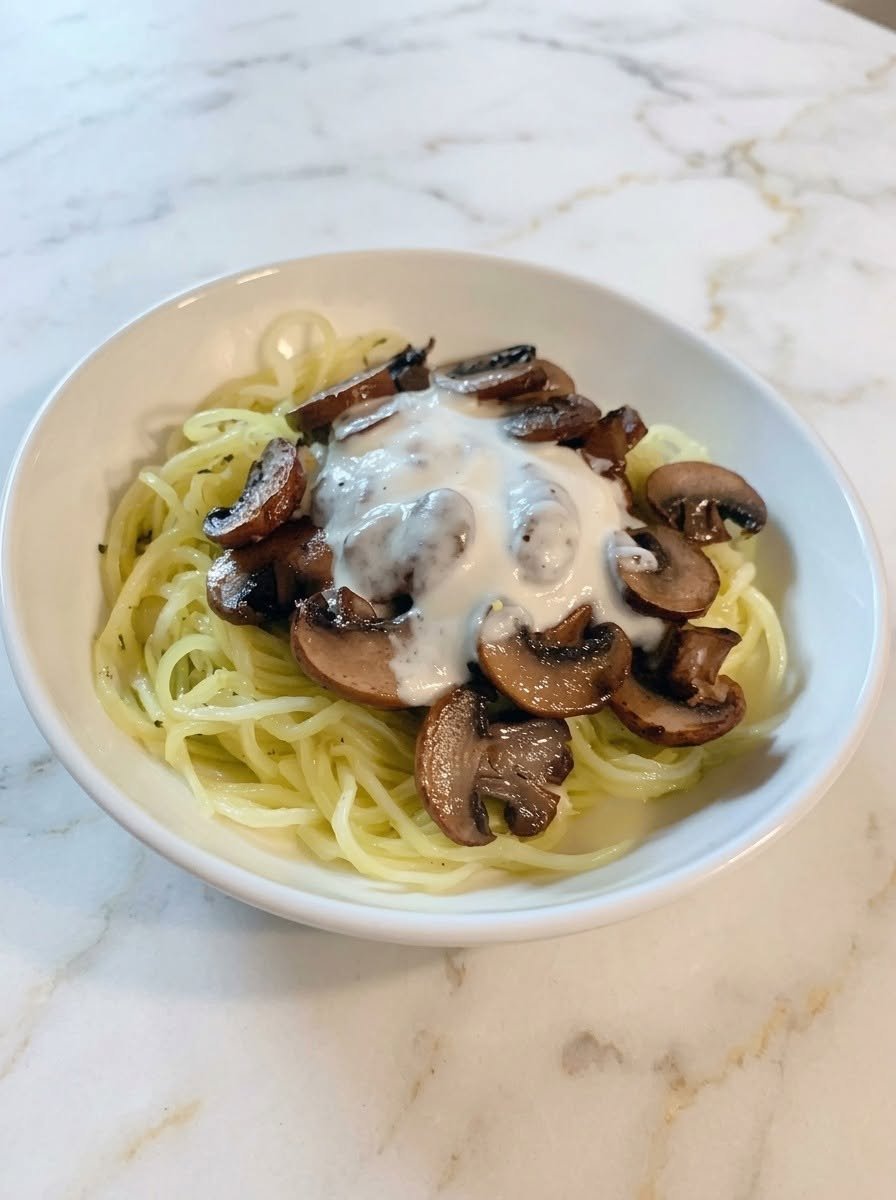 Keto Italian Sausage with Alfredo Sauce Over Cabbage Noodles There are some dinners that feel like they should be complicated. Something creamy. Something cheesy. Something with Italian sausage. Something that makes the whole kitchen smell amazing. But this Keto Italian Sausage with Alfredo Sauce Over Cabbage Noodles is surprisingly simple. I first made this on a night when I was craving a big bowl of creamy Alfredo pasta but didn't want the heavy pasta afterward. I had Italian sausage sitting in the refrigerator and a beautiful head of cabbage on the counter, so I decided to put the two together. And honestly? I wasn't expecting to love it quite as much as I did. The sausage gets browned until the edges are beautifully caramelized, then everything gets coated in a rich garlic-Parmesan Alfredo sauce. Instead of traditional noodles, tender cabbage strips soak up all that creamy sauce while still keeping enough texture to make every bite satisfying. I made it on a weekend when everyone was hungry, and the skillet disappeared much faster than I expected. Even the people who normally turn their noses up at cabbage went back for seconds. That was my sign that this recipe was staying in the rotation. It's cozy, creamy, savory, and incredibly comforting. And nobody at the table was asking where the regular pasta went. 🍝 Why You'll Love This Keto Sausage Alfredo Rich and creamy without traditional pasta Packed with savory Italian sausage Tender cabbage makes a surprisingly good noodle substitute Garlic and Parmesan give the Alfredo sauce incredible flavor Ready in about 30 minutes Perfect for busy weeknights Easy to customize with vegetables and spices Naturally low in carbohydrates when keto-friendly sausage and other packaged ingredients are used Everything comes together in one main skillet This is one of those meals that tastes much more indulgent than the amount of work required to make it. 🛒 Ingredients For the Sausage & Cabbage 1 pound Italian sausage links or bulk Italian sausage 1 medium green cabbage, about 6 cups sliced 2 tablespoons butter, divided ½ small yellow onion, thinly sliced 3 cloves garlic, minced ½ teaspoon salt ¼ teaspoon black pepper ½ teaspoon Italian seasoning ¼ teaspoon red pepper flakes, optional For the Alfredo Sauce 2 tablespoons unsalted butter 3 cloves garlic, minced 1½ cups heavy cream ¾ cup freshly grated Parmesan cheese ½ teaspoon Italian seasoning ¼ teaspoon black pepper Pinch of nutmeg, optional Salt, to taste For Finishing 2 tablespoons chopped fresh parsley ¼ cup additional Parmesan cheese Freshly cracked black pepper Optional red pepper flakes 👩‍🍳 How to Make Keto Italian Sausage with Alfredo Sauce 1. Prepare the Cabbage Remove any tough outer leaves from the cabbage. Cut it into quarters and remove the hard core. Slice each quarter into thin strips, about ¼ inch wide. These cabbage strips will become our “noodles.” Try not to make them too thin. You want them tender enough to eat easily but sturdy enough to hold onto that creamy Alfredo sauce. 🌭 2. Cook the Italian Sausage If you're using sausage links, remove the casings. Heat 1 tablespoon butter in a large skillet over medium-high heat. Add the sausage. Break it apart with a wooden spoon if you're using bulk sausage. Cook for approximately 7–10 minutes, stirring occasionally, until the sausage is browned and cooked through. If you're using sliced sausage links, let the pieces sit undisturbed for a minute or two at a time so they develop those delicious golden edges. Once cooked, transfer the sausage to a plate. Leave the flavorful browned bits in the skillet. That's where the good stuff is. 🧅 3. Sauté the Onion and Garlic Add the remaining tablespoon of butter to the skillet. Add the sliced onion. Cook for about 3–4 minutes, until it begins to soften. Add the minced garlic. Cook for another 30–60 seconds, just until fragrant. Don't let the garlic burn. Burnt garlic can overpower the entire dish. 🥬 4. Cook the Cabbage Add the sliced cabbage to the skillet. Season with salt, black pepper, Italian seasoning, and red pepper flakes if you're using them. Toss everything together. Cook for approximately 7–10 minutes, stirring frequently, until the cabbage becomes tender but still has a little bite. Don't cook it until it's completely soft and mushy. You want the texture to resemble noodles rather than mashed cabbage. If the skillet looks dry, add another small pat of butter. 🧄 5. Make the Alfredo Sauce You can make the Alfredo sauce in the same skillet after moving the cabbage to one side, or use a separate saucepan. Melt the butter over medium-low heat. Add the minced garlic. Cook for about 30 seconds, just until fragrant. Pour in the heavy cream. Add the Italian seasoning, black pepper, and optional nutmeg. Bring the mixture to a gentle simmer. Do not let it boil aggressively. 🧀 6. Add the Parmesan Reduce the heat to low. Gradually add the freshly grated Parmesan, stirring continuously. Keep stirring until the cheese melts into the cream and the sauce becomes smooth and creamy. If the sauce becomes too thick, add a small splash of heavy cream. If it seems too thin, let it simmer gently for another minute or two. Freshly grated Parmesan generally melts more smoothly than pre-shredded cheese. 🌭 7. Bring Everything Together Return the cooked Italian sausage to the skillet. Pour the Alfredo sauce over the sausage and cabbage. Gently toss everything together. Let it cook for another 2–3 minutes over low heat so the flavors can mingle. This is the moment when the whole dish comes together. The sausage flavors the sauce. The cabbage picks up the garlic and Parmesan. And the Alfredo coats every little piece. 🌿 8. Finish and Serve Turn off the heat. Sprinkle the dish with fresh parsley and additional Parmesan. Add freshly cracked black pepper and a few red pepper flakes if you like some heat. Serve immediately while the Alfredo is warm and silky. And don't forget to scrape every last bit of sauce from the bottom of the skillet. ⭐ The Secret to Great Cabbage “Noodles” The cabbage doesn't need to be completely soft. In fact, that's one of the easiest ways to ruin this dish. You want it tender but slightly firm. If you cook it too long, it can release a lot of water and make the Alfredo sauce thinner. A quick sauté over medium-high heat works beautifully. And make sure you slice the cabbage into fairly even strips so everything cooks at roughly the same rate. 🧀 Tips for Creamy Alfredo Sauce Use freshly grated Parmesan It melts beautifully and gives the sauce a smoother texture. Keep the heat low High heat can cause dairy-based sauces to separate. Don't boil the cream A gentle simmer is all you need. Add Parmesan gradually Adding it a little at a time helps it incorporate smoothly. Taste before adding more salt Parmesan and Italian sausage can both be quite salty. 🌶️ Easy Variations Spicy Italian Sausage Alfredo Use hot Italian sausage and add extra red pepper flakes. This is my favorite version when I want a little heat. Garlic Parmesan Sausage Alfredo Add another clove or two of garlic to the sauce and finish with extra Parmesan. There is no such thing as too much garlic when you're making this kind of dinner. Mushroom Sausage Alfredo Sauté sliced mushrooms with the onions before adding the cabbage. The earthy mushrooms are fantastic with sausage and cream sauce. Spinach Sausage Alfredo Add a few handfuls of fresh spinach during the final few minutes of cooking. Let it wilt directly into the Alfredo. Broccoli Alfredo Add small broccoli florets and cook until tender-crisp before combining everything. Bacon Sausage Alfredo Add crispy chopped bacon to the finished dish. This turns an already comforting dinner into something seriously indulgent. Cajun Sausage Alfredo Season the sausage and cabbage with Cajun seasoning instead of Italian seasoning. The creamy Alfredo sauce works surprisingly well with Cajun spices. 🥦 What to Serve With Sausage Alfredo This is already a hearty meal, but you can add a simple vegetable side if you like. Try: Roasted broccoli Green beans Asparagus Simple green salad Roasted zucchini Sautéed spinach Cauliflower Garlic mushrooms If you want to keep everything especially simple, just serve the sausage Alfredo in large bowls with a little extra Parmesan. That's more than enough. 🍽️ Can I Use Another Keto “Noodle”? Absolutely. If cabbage isn't your favorite, try: Zucchini Noodles Quick and fresh, although they release more water than cabbage. Hearts of Palm Noodles A convenient option with a mild flavor. Shirataki Noodles Rinse and dry them thoroughly before adding them to the sauce. Spaghetti Squash Roast the squash separately, then toss the strands with the sausage and Alfredo. Cauliflower For a completely noodle-free version, use roasted cauliflower florets instead. Low-carb Alfredo sauces are commonly paired with vegetables and alternative noodles such as zucchini, hearts of palm, and shirataki. 🧊 Storage Allow leftovers to cool before transferring them to an airtight container. Store in the refrigerator for up to 3–4 days. Because the Alfredo sauce thickens as it chills, add a small splash of heavy cream when reheating if necessary. Warm gently on the stovetop or in the microwave. Avoid overheating because the sauce can separate. ❄️ Can You Freeze Sausage Alfredo? You can, but I prefer eating this fresh or refrigerated. Cream-based sauces can sometimes change texture after freezing and thawing. If you do freeze it, cool it completely first and store it in a freezer-safe container. Thaw overnight in the refrigerator and reheat gently. The cabbage may become softer than it was originally. 🕐 Can I Make This Ahead? Yes. You can cook the sausage and cabbage ahead of time and refrigerate them separately. Prepare the Alfredo sauce shortly before serving for the smoothest texture. When dinner time arrives, gently reheat the sausage and cabbage, warm the Alfredo, and combine everything. It's an easy way to make a busy evening much less stressful. ❓ Frequently Asked Questions Is Italian sausage keto-friendly? Many Italian sausages can fit a keto-style meal, but carbohydrate content varies by brand. Check the package for added sugar, breadcrumbs, starches, or other higher-carb ingredients. What can I use instead of cabbage? Zucchini noodles, shirataki noodles, hearts of palm noodles, spaghetti squash, or cauliflower all work well. Can I use pre-made Alfredo sauce? Yes. Choose a sauce with ingredients and carbohydrate content that fit your dietary needs. Why did my Alfredo sauce separate? Usually, the heat was too high or the sauce was boiled aggressively. Keep the heat low and add the Parmesan gradually. Can I use pre-shredded Parmesan? You can, but freshly grated Parmesan generally melts more smoothly. Can I use chicken sausage? Absolutely. Chicken sausage works beautifully if you prefer a lighter sausage. Can I add cream cheese? Yes. A small amount of cream cheese can make the sauce even thicker and richer. Can I make this dairy-free? You would need dairy-free substitutes for the butter, cream, and Parmesan. The final flavor and texture will be different, but the basic method can still work. How do I keep cabbage from becoming watery? Don't overcrowd the skillet, don't overcook it, and avoid covering it while sautéing. You want moisture to evaporate rather than collect in the pan. Can I make this spicy? Definitely. Use hot Italian sausage, red pepper flakes, cayenne, or a little hot sauce. 🍽️ Recipe at a Glance Prep Time: 10 minutes Cook Time: 20 minutes Total Time: About 30 minutes Servings: 4–6 Category: Dinner Cuisine: Italian-American inspired Cooking Method: Stovetop ❤️ The Creamy Sausage Dinner I Keep Coming Back To There is something incredibly comforting about a skillet full of Italian sausage and creamy Alfredo sauce. But what I love most about this version is that it doesn't feel like you're eating a “replacement” meal. The cabbage isn't trying desperately to pretend it's pasta. It's simply doing its own thing—and doing it really well. It stays tender, catches all that creamy garlic-Parmesan sauce, and gives you enough texture to make every forkful satisfying. Then you get those little pieces of browned Italian sausage. A little Parmesan. Fresh parsley. Maybe some red pepper flakes. And suddenly you're sitting at the table wondering how something this simple tastes this good. This has become one of those recipes I make when I'm craving comfort food, especially on weekends when I want something hearty without spending hours in the kitchen. And the best part? The leftovers are just as tempting the next day. So grab your skillet, brown that sausage, slice up some cabbage, and make the Alfredo. Creamy, cheesy, savory, and wonderfully comforting—this is keto comfort food done right.