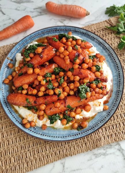 Spiced Honey Carrots with Whipped Feta There are side dishes that quietly sit next to the main meal. And then there are side dishes that make everyone ask, “What did you do to the carrots?” These Spiced Honey Carrots with Whipped Feta are definitely the second kind. I used to think of carrots as one of those vegetables you added to dinner because you were supposed to eat more vegetables. Not anymore. When carrots are roasted until their edges become caramelized and tender, then coated with warm spices and a little honey, they become something completely different. Sweet. Savory. A little smoky. And absolutely irresistible. The whipped feta is what really makes this recipe special. It's creamy, tangy, salty, and wonderfully smooth. When you drag a warm, sticky roasted carrot through that cool feta, you get this incredible combination of flavors and textures. I made these recently for a weekend family dinner, expecting them to be a simple vegetable side. Instead, everyone kept reaching for another carrot. One person asked for extra feta. Someone else wanted more of the honey-spice glaze. And by the end of the meal, the serving platter was completely empty. That's when I knew these carrots deserved a permanent place in my recipe rotation. ❤️ Why You'll Love These Spiced Honey Carrots Naturally sweet roasted carrots Warm Moroccan-inspired spices Sticky honey glaze Creamy whipped feta Easy enough for a weeknight Beautiful enough for a dinner party Vegetarian-friendly Excellent alongside grilled meats Full of contrasting textures Can be prepared ahead The combination sounds simple, but it tastes anything but ordinary. 🛒 Ingredients For the Roasted Carrots 1½ pounds carrots, peeled and trimmed 1½ tablespoons olive oil 2 tablespoons honey 1 teaspoon ground cumin 1 teaspoon smoked paprika ½ teaspoon ground coriander ¼ teaspoon cinnamon ¼ teaspoon cayenne pepper, optional ½ teaspoon salt ¼ teaspoon freshly ground black pepper For the Whipped Feta 6 ounces feta cheese, crumbled ¼ cup plain Greek yogurt 1 tablespoon extra-virgin olive oil 1 tablespoon fresh lemon juice 1 small garlic clove 1–2 tablespoons water, as needed For Finishing 1 tablespoon chopped fresh parsley 1 tablespoon chopped fresh mint 1 teaspoon sesame seeds Extra honey, optional Lemon zest Pinch of red pepper flakes 🥕 Choosing Your Carrots You can use regular carrots for this recipe, and they work beautifully. If you find smaller bunch carrots with their tops attached, those are also lovely. The most important thing is to choose carrots that are relatively similar in size. If some carrots are very thick while others are tiny, the smaller ones may become soft before the larger ones are cooked through. For larger carrots, cut them lengthwise into halves or quarters. The goal is to create pieces that roast evenly and develop plenty of caramelized edges. 👩🍳 How to Make Spiced Honey Carrots with Whipped Feta 1. Preheat the Oven Preheat your oven to 425°F (220°C). Line a large baking sheet with parchment paper. You want the oven nice and hot so the carrots roast rather than simply soften. 🥕 2. Prepare the Carrots Wash and peel the carrots. Trim the ends. If they're small, you can leave them whole. If they're larger, cut them lengthwise into halves or quarters. Place the carrots in a large bowl. Add the olive oil, cumin, smoked paprika, coriander, cinnamon, cayenne, salt, and black pepper. Toss until every carrot is coated in the spices. 🔥 3. Roast the Carrots Spread the carrots across the prepared baking sheet. Keep them in a single layer and leave a little space between them. Roast for approximately 20–25 minutes. Turn them halfway through cooking. You want the carrots to become tender with browned, caramelized edges. Don't worry if some of the thinner pieces become deeply golden. Those are usually the first ones everyone fights over. 🍯 4. Add the Honey While the carrots roast, mix the honey with a tablespoon of olive oil or a teaspoon of warm water to make it easier to drizzle. After the carrots have roasted for about 20 minutes, remove the tray from the oven. Drizzle the honey over the carrots. Toss gently to coat. Return the tray to the oven for another 5–10 minutes. The honey will become sticky and glossy while the carrots continue caramelizing. Keep an eye on them during this final stage because honey can darken quickly. 🧀 5. Make the Whipped Feta While the carrots finish cooking, make the feta. Add the feta, Greek yogurt, olive oil, lemon juice, and garlic to a food processor. Blend until smooth and creamy. If it feels too thick, add water one tablespoon at a time. Stop when the feta reaches a soft, spreadable consistency. Taste it. Depending on how salty your feta is, you may not need any additional salt. 🌿 6. Prepare the Garnishes Finely chop the parsley and mint. Toast the sesame seeds briefly in a dry skillet if you'd like extra flavor. You can also prepare a little lemon zest for sprinkling over the finished dish. Fresh herbs are especially helpful here because they brighten the rich feta and sweet roasted carrots. 🍽️ 7. Assemble the Dish Spread the whipped feta across a large serving platter. Use the back of a spoon to create gentle swirls. Arrange the hot roasted carrots over the feta. Drizzle with a little extra honey. Sprinkle with parsley, mint, sesame seeds, and lemon zest. Finish with a pinch of red pepper flakes if you like heat. And that's it. It looks like you've spent much more time on it than you actually have. ⭐ Tips for Perfect Spiced Honey Carrots Don't overcrowd the baking sheet Give the carrots room to roast. If they're packed too tightly, they'll steam instead of caramelize. Cut the carrots evenly Similar-sized pieces will cook at the same rate. Add honey toward the end Honey can burn if exposed to high heat for too long. Adding it during the final part of roasting gives you that beautiful sticky finish without making it bitter. Don't skip the spices Cumin and coriander give the carrots a warm, earthy flavor that balances their natural sweetness. Taste your feta Some feta is much saltier than others. Taste before adding extra salt. Serve immediately The contrast between warm carrots and cool whipped feta is one of the best parts of the dish. 🌶️ Adjust the Spice Level You can make these carrots as mild or spicy as you like. Mild Skip the cayenne and red pepper flakes. Medium Use ¼ teaspoon cayenne. Spicy Add cayenne plus red pepper flakes. For serious heat, add a little harissa to the honey mixture. 🍯 Make Them Extra Sticky If you love that glossy, caramelized coating, make a quick glaze. Mix: 2 tablespoons honey 1 teaspoon olive oil ½ teaspoon cumin Pinch of cayenne 1 teaspoon lemon juice Brush it over the carrots during the final few minutes of roasting. Don't add it too early. You want the carrots to roast first and become tender before the glaze gets sticky. 🧀 Why Whipped Feta Works So Well This is the part that turns a simple roasted vegetable into something special. The carrots are: Sweet + warm + caramelized. The feta is: Cool + creamy + salty + tangy. Put them together and every bite balances the one before it. The Greek yogurt also softens the sharpness of the feta and gives it a silky texture. If you've never whipped feta before, this is a great recipe to try it with. 🌿 Add Crispy Chickpeas If you want to turn this side dish into a more substantial vegetarian meal, add crispy roasted chickpeas. Season chickpeas with: Olive oil Cumin Paprika Salt Black pepper Roast until crisp and scatter them over the carrots and whipped feta. The crunch is fantastic. 🥜 Add Nuts for Crunch Toasted nuts work beautifully with the sweet honey and creamy feta. Try: Pistachios Almonds Walnuts Pecans Hazelnuts Pistachios are especially good with the mint and feta. 🍋 Add More Freshness If the dish feels a little too rich, brighten it with fresh lemon. Try: Lemon zest Lemon juice Fresh mint Fresh parsley Pomegranate seeds Pomegranate seeds are particularly beautiful for a holiday or dinner-party presentation. 🥗 Turn It Into a Bowl These carrots can easily become the star of a complete meal. Start with: Couscous Quinoa Brown rice Farro Mixed greens Add the roasted carrots and whipped feta. Then top with: Crispy chickpeas Cucumber Fresh herbs Toasted pistachios Pomegranate seeds Hot honey Now you've got a gorgeous Mediterranean-inspired grain bowl. 🍗 What to Serve With Spiced Honey Carrots These carrots pair especially well with savory mains. Serve them alongside: Roast chicken Grilled chicken Lamb chops Grilled lamb Beef tenderloin Pork chops Roasted salmon Baked cod Grilled shrimp They're also wonderful as part of a vegetarian dinner with hummus, warm pita, roasted vegetables, and a fresh salad. 🫓 Make a Mediterranean-Inspired Platter For entertaining, I love serving these carrots as part of a larger spread. Add: Whipped feta Hummus Warm pita Olives Cucumber Cherry tomatoes Roasted eggplant Crispy chickpeas Fresh herbs Place the carrots in the center. It becomes one of those tables where everyone keeps going back for "just one more thing." 🥕 Other Vegetables You Can Use The same flavor combination works with plenty of other vegetables. Try: Sweet Potato Roast cubes until caramelized and finish with the honey-spice glaze. Butternut Squash The natural sweetness works beautifully with feta. Cauliflower Use more cumin and smoked paprika for a savory version. Parsnips Their natural sweetness makes them especially good with honey. Brussels Sprouts The crispy leaves are fantastic with whipped feta. Pumpkin Perfect for an autumn-inspired version. 🧊 Can You Make These Ahead? Yes. You can roast the carrots several hours ahead of time. Make the whipped feta separately and refrigerate it. When you're ready to serve, gently reheat the carrots in a hot oven until warmed through. Then assemble everything just before serving. For the best presentation, don't assemble the carrots over the feta until you're ready to eat. 🧊 How to Store Leftovers Store the roasted carrots and whipped feta separately in airtight containers. Refrigerate for up to 3–4 days. Reheat the carrots in a skillet or oven. The whipped feta can be served cold or allowed to sit at room temperature briefly before serving. ❄️ Can You Freeze Them? The roasted carrots can be frozen, although they may become softer after thawing. I don't recommend freezing the whipped feta because the texture can change after freezing and thawing. For the best results, prepare the components fresh or refrigerate them for a few days. ❓ Frequently Asked Questions Can I use baby carrots? Yes. Baby carrots are convenient and work well. Choose ones that are relatively similar in size. Can I leave the carrots unpeeled? Absolutely, especially if you're using young carrots. Just wash and scrub them thoroughly. Can I use maple syrup instead of honey? Yes. Maple syrup is a delicious alternative and gives the carrots a slightly deeper flavor. Can I make these carrots without honey? Yes. The carrots will still caramelize naturally, although they won't have quite the same sticky glaze. Can I use regular feta? Yes. Feta is the star of the whipped topping, so use a variety you enjoy. Can I use cream cheese instead of Greek yogurt? Yes, although the whipped feta will become richer and less tangy. Can I make the whipped feta without a food processor? Yes. Mash the feta very thoroughly with a fork and stir in the yogurt, olive oil, lemon juice, and garlic. It won't be quite as silky, but it will still taste delicious. Can I use frozen carrots? Fresh carrots are preferable because they roast and caramelize better. Frozen carrots contain more moisture and may become softer. How spicy are these carrots? The base recipe is mildly spiced. The cayenne is optional, so you can easily adjust the heat. Can I make this vegan? Yes. Use a dairy-free feta alternative and replace the honey with maple syrup or another vegan sweetener. Can I add chickpeas? Absolutely. Crispy roasted chickpeas are one of my favorite additions and can turn this into a more substantial meal. What herbs work best? Mint and parsley are excellent. Cilantro and dill can also work depending on the rest of your meal. Can I serve this cold? Yes, although I prefer the carrots warm or at room temperature with cool whipped feta. 📝 Recipe at a Glance Recipe: Spiced Honey Carrots with Whipped Feta Prep Time: 15 minutes Cook Time: 30–35 minutes Total Time: About 45–50 minutes Servings: 4–6 Category: Side Dish / Appetizer Cuisine: Mediterranean-inspired Method: Oven Ingredients Carrots 1½ pounds carrots 1½ tablespoons olive oil 2 tablespoons honey 1 teaspoon cumin 1 teaspoon smoked paprika ½ teaspoon coriander ¼ teaspoon cinnamon ¼ teaspoon cayenne, optional ½ teaspoon salt ¼ teaspoon black pepper Whipped Feta 6 ounces feta ¼ cup Greek yogurt 1 tablespoon olive oil 1 tablespoon lemon juice 1 small garlic clove 1–2 tablespoons water Garnish Fresh parsley Fresh mint Sesame seeds Lemon zest Extra honey Red pepper flakes, optional Instructions Preheat oven to 425°F (220°C). Wash, peel, and cut carrots into evenly sized pieces. Toss carrots with olive oil, cumin, paprika, coriander, cinnamon, cayenne, salt, and pepper. Spread carrots on a lined baking sheet. Roast for 20–25 minutes, turning halfway through. Drizzle with honey and return to the oven for another 5–10 minutes. Blend feta, Greek yogurt, olive oil, lemon juice, and garlic until creamy. Add water as needed to reach a smooth consistency. Spread whipped feta over a serving platter. Arrange the warm carrots over the feta. Drizzle with additional honey. Garnish with parsley, mint, sesame seeds, lemon zest, and optional red pepper flakes. Serve warm or at room temperature. ❤️ The Carrot Recipe That Changed My Mind I honestly love when a recipe takes an ingredient I thought I knew and makes me look at it differently. That's exactly what happens with these carrots. They're not boiled. They're not plain. They're not sitting quietly on the side of the plate. They're roasted until caramelized, coated with warm spices, finished with honey, and served over a cloud of creamy whipped feta. Every bite gives you something different. The sweetness of the carrot. The warmth of the spices. The tangy feta. The freshness of the herbs. And that little hit of honey at the end. It's simple enough for a weeknight dinner but beautiful enough to put on the table when you're entertaining. And if your family normally reaches for the potatoes before the vegetables? Make these. You might be surprised how quickly the carrots disappear. Sweet, spicy, creamy, caramelized, and completely irresistible.