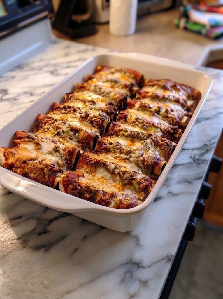 🧀 Keto Lasagna Without Noodles If you love lasagna but don't want the heavy pasta, this Keto Lasagna Without Noodles is exactly the kind of recipe to keep in your back pocket. I made this on a weekend when I was craving something seriously cheesy and comforting, but I didn't want to make a traditional pan of lasagna. I had zucchini sitting in the refrigerator, ground beef ready to cook, and a few containers of cheese begging to be used. So I decided to see if I could make a lasagna that didn't actually need noodles. The result was better than I expected. You get layers of tender zucchini, rich Italian-seasoned beef, creamy ricotta, bubbling mozzarella, and Parmesan with those beautiful golden edges on top. It has all the cozy flavors I want from lasagna without the traditional pasta. And once it comes out of the oven bubbling and golden, nobody seems to miss the noodles. ❤️ Why You'll Love This Keto Lasagna No traditional noodles Low-carb and keto-friendly when using a suitable marinara Loaded with beef and three kinds of cheese Comforting and incredibly satisfying Great for family dinners Easy to make ahead Delicious leftovers Perfect for meal prep Zucchini is a popular noodle replacement in keto lasagna because it provides the layered structure of pasta while keeping the dish much lower in carbohydrates. 🛒 Ingredients You'll Need For the Zucchini Layers 3 large zucchini 1 tablespoon olive oil 1/2 teaspoon salt For the Meat Sauce 1 pound ground beef 1 tablespoon olive oil 1/2 small yellow onion, finely diced 3 cloves garlic, minced 1 1/2 cups low-carb marinara sauce 1 teaspoon Italian seasoning 1/2 teaspoon dried oregano 1/2 teaspoon salt 1/4 teaspoon black pepper 1/4 teaspoon red pepper flakes, optional For the Cheese Layer 15 ounces whole-milk ricotta cheese 1 large egg 1/2 cup grated Parmesan cheese 1 teaspoon Italian seasoning 1/2 teaspoon garlic powder 1 1/2 cups shredded mozzarella cheese For the Top 1 cup shredded mozzarella cheese 2 tablespoons grated Parmesan Fresh basil or parsley, optional Important: If you're following keto closely, choose a marinara sauce with no added sugar and check the carbohydrate count on the label. 👩🍳 How to Make Keto Lasagna Without Noodles 1. Slice the Zucchini Preheat your oven to 400°F (200°C). Wash and dry the zucchini. Slice each zucchini lengthwise into thin strips, approximately 1/8 to 1/4 inch thick. A mandoline makes this especially easy, but a sharp knife works too. Try to keep the slices relatively even so they cook at the same rate. 2. Remove Excess Moisture This is probably the most important step in the whole recipe. Zucchini contains a lot of water, and if you put raw slices directly into your lasagna, that moisture can turn your beautiful casserole into a watery mess. Arrange the zucchini slices on paper towels or a clean kitchen towel. Sprinkle lightly with salt and let them sit for 10–15 minutes. Blot the moisture that comes to the surface. For an even drier lasagna, arrange the slices on a parchment-lined baking sheet, brush lightly with olive oil, and bake for 8–10 minutes, just until they soften slightly. Don't cook them until mushy. The goal is to remove excess moisture while keeping them sturdy enough to layer. Tested zucchini-lasagna recipes specifically recommend salting/draining or pre-cooking the zucchini to help prevent a watery finished dish. 🍅 3. Make the Meat Sauce While the zucchini is draining, heat 1 tablespoon olive oil in a large skillet over medium-high heat. Add the ground beef. Cook for 5–7 minutes, breaking it apart with a wooden spoon until browned and cooked through. Add the diced onion and cook for another 3–4 minutes, until softened. Add the garlic and cook for about 30 seconds. Stir in: Marinara sauce Italian seasoning Oregano Salt Black pepper Red pepper flakes, if using Reduce the heat and simmer for 5 minutes. You don't want a watery meat sauce. Letting it simmer briefly helps thicken it before it goes into the lasagna. Remove from the heat. 🧀 4. Make the Ricotta Mixture In a medium bowl, combine: Ricotta Egg Parmesan Italian seasoning Garlic powder Mix until smooth and well combined. The egg helps the cheese layer set as the lasagna bakes. 🥘 5. Start Layering Lightly grease a 9 x 13-inch baking dish. Spread a thin layer of meat sauce over the bottom. Add a layer of zucchini slices, slightly overlapping them. Spread about half of the ricotta mixture over the zucchini. Spoon half of the remaining meat sauce over the ricotta. Sprinkle with about half of the mozzarella. Then repeat: Zucchini → ricotta → meat sauce → mozzarella Finish with a final layer of zucchini. Spread a little remaining meat sauce over the top. Then cover generously with the remaining mozzarella and Parmesan. 🔥 6. Bake Cover the baking dish loosely with aluminum foil. Bake at 400°F for 25 minutes. Remove the foil and continue baking for another 10–15 minutes, until the cheese is melted, bubbling, and golden. If you want a deeply browned top, broil for 1–2 minutes at the end. Watch it carefully. Cheese can brown incredibly quickly under the broiler. ⏰ 7. Let It Rest This step is easy to skip—and I know it's tempting. Don't. Let the lasagna rest for at least 10–15 minutes before cutting. The cheese and meat layers need a little time to settle, and resting makes it much easier to get those beautiful layered slices instead of a pile of deliciousness on the plate. For an especially clean slice, give it closer to 20 minutes. 🍽️ How to Serve It Cut the lasagna into squares and garnish with fresh basil or parsley. I love serving it with: Crisp green salad Garlic butter broccoli Roasted cauliflower Sautéed spinach Garlic mushrooms Steamed green beans Caesar salad Keto garlic bread If you're serving a crowd, a simple green salad is all you really need. The lasagna is already rich, cheesy, and filling. 💡 How to Keep Keto Lasagna From Getting Watery This is the question I get most often with zucchini lasagna, and honestly, it's worth paying attention to. 1. Salt the zucchini A little salt draws moisture from the zucchini. 2. Blot it thoroughly Don't just let it sit. Use paper towels to absorb the moisture. 3. Pre-bake the zucchini This is my favorite method because it removes additional moisture while giving the zucchini a head start. 4. Don't make the meat sauce watery Simmer your sauce for a few minutes so it thickens. 5. Drain your ricotta if necessary If your ricotta looks particularly wet, place it in a fine-mesh strainer for several minutes before using it. 6. Don't cut the lasagna immediately Resting allows the layers to firm up. Zucchini-lasagna recipes consistently highlight moisture control as the trick to getting slices that hold together instead of becoming watery. 🧀 Best Cheese Combination I love using ricotta, mozzarella, and Parmesan together. Each one does something different. Ricotta: creates the creamy layer. Mozzarella: gives you that stretchy, bubbling cheese topping. Parmesan: adds salty, nutty flavor and helps create a beautiful golden crust. You can also experiment with: Provolone Fontina Monterey Jack Cheddar Cottage cheese If using cottage cheese, drain it first if it contains a lot of liquid. 🌶️ Easy Variations Keto Sausage Lasagna Replace half or all of the ground beef with Italian sausage. Hot Italian sausage is especially delicious. Beef & Spinach Lasagna Stir 1 cup chopped cooked spinach into the ricotta mixture. Make sure to squeeze out as much water as possible first. Mushroom Lasagna Sauté sliced mushrooms with the onions and add them to the meat sauce. Extra Cheesy Lasagna Add a layer of shredded provolone along with the mozzarella. Creamy White Lasagna Skip the tomato sauce and make a creamy garlic Alfredo-style sauce instead. Layer it with zucchini, ricotta, Parmesan, mozzarella, and cooked chicken. Turkey Lasagna Use ground turkey instead of beef. Add a little extra olive oil or cheese to keep the filling rich. Spicy Keto Lasagna Use hot Italian sausage, extra red pepper flakes, and a little Calabrian chili paste. 🥒 Can I Use Eggplant Instead of Zucchini? Absolutely. Thinly sliced eggplant makes another excellent noodle substitute. Slice it lengthwise, salt it lightly, let it sit, then pat it dry before roasting until slightly softened. Eggplant will give you a deeper, more savory flavor, while zucchini has a lighter taste. 🍆 Can I Use Both Zucchini and Eggplant? Yes—and it's actually a fantastic combination. Use alternating layers of zucchini and eggplant for more texture and flavor. Just make sure both vegetables are pre-cooked enough to remove excess moisture before assembling the lasagna. 🥩 Can I Use Italian Sausage? Definitely. Italian sausage adds more seasoning and fat than lean ground beef, which makes a particularly rich lasagna. You can use: Mild Italian sausage Hot Italian sausage Chicken sausage Turkey sausage If your sausage is already heavily seasoned, reduce the added salt accordingly. 🥗 What Makes This Lasagna Keto? Traditional lasagna relies on wheat-based pasta sheets, which contribute a significant amount of carbohydrates. This version replaces those sheets with zucchini and uses a low-carb marinara, meat, ricotta, mozzarella, and Parmesan. However, the exact carbohydrate count depends heavily on the vegetables, cheese, and especially the marinara sauce you choose, so check your specific ingredient labels rather than assuming every version has the same macros. ⏰ Can I Make It Ahead? Yes. You can assemble the entire lasagna up to 24 hours ahead. Cover it tightly and refrigerate. When you're ready to bake, remove it from the refrigerator while the oven preheats. Because the casserole will be cold, you may need to add approximately 10 minutes to the baking time. Don't leave an assembled casserole sitting at room temperature for an extended period. 🧊 How to Store Leftovers Let the lasagna cool before transferring leftovers to an airtight container. Refrigerate for up to 4 days. The flavor is actually even better the next day because all those layers have time to mingle. ❄️ Can You Freeze Keto Lasagna? Yes. Let the cooked lasagna cool completely. Cut it into individual portions and wrap each piece tightly. Place the wrapped portions in a freezer-safe container or bag and freeze for up to 2–3 months for best quality. Thaw overnight in the refrigerator before reheating. You can also freeze individual portions for easy lunches. 🔥 How to Reheat Oven Place a portion in an oven-safe dish and cover loosely with foil. Bake at 350°F for 15–20 minutes, or until heated through. Air Fryer Reheat at 350°F for about 5–8 minutes, depending on the thickness. Microwave Microwave individual portions in 60–90 second intervals until hot. The oven gives the best texture, especially if you want the cheese topping to become bubbly again. ❓ Frequently Asked Questions Can I make keto lasagna without zucchini? Yes. You can use eggplant, cabbage leaves, thin slices of deli meat, or even make a completely noodle-free layered casserole with meat and cheese. Is this lasagna really noodle-free? Yes. There are no traditional pasta sheets in this recipe. The zucchini provides the layered structure. Can I skip the zucchini pre-baking? You can, but I don't recommend it. Raw zucchini releases a lot of water while baking. Pre-cooking or salting and thoroughly drying the slices produces a much better texture. Can I use cottage cheese instead of ricotta? Yes. Cottage cheese works particularly well if you prefer a higher-protein filling. Drain excess liquid before using. What marinara sauce should I use? Choose a tomato sauce with no added sugar and relatively low carbohydrates. Always check the nutrition label because brands vary considerably. Why did my lasagna fall apart? It may simply need more resting time. Also make sure the zucchini isn't too watery and avoid cutting into the lasagna immediately after it comes out of the oven. Can I make this with ground sausage? Yes. Italian sausage is an excellent substitute for ground beef. Can I add spinach? Absolutely. Mix well-drained cooked spinach into the ricotta layer for extra vegetables and color. Can I make it vegetarian? Yes. Replace the beef with sautéed mushrooms, spinach, zucchini, and/or eggplant. You'll want to make sure the marinara and cheese choices remain keto-friendly. How long should keto lasagna rest? I recommend 10–15 minutes, although 20 minutes will give you even cleaner slices. 📝 Recipe at a Glance Recipe: Keto Lasagna Without Noodles Prep Time: 25 minutes Cook Time: 40 minutes Resting Time: 10–15 minutes Total Time: About 1 hour 20 minutes Servings: 8 Course: Dinner Cuisine: Italian-inspired Diet: Keto / Low Carb Difficulty: Easy to Moderate ❤️ Final Thoughts This Keto Lasagna Without Noodles is proof that you don't always need the traditional ingredients to make a seriously comforting dinner. The first time I made it, I wasn't sure whether zucchini could really replace lasagna sheets. But after that first forkful of tender zucchini, rich beef sauce, creamy ricotta, and bubbling mozzarella, I stopped worrying about the missing noodles. It has everything I want from a cozy lasagna night. It's cheesy. It's saucy. It's hearty. And it makes the kitchen smell absolutely incredible while it's baking. I especially love making this on weekends when everyone is home and I have a little more time to let the lasagna rest properly before serving it. And somehow, the leftovers always seem to taste even better the next day. So if you've been missing lasagna while following a keto or low-carb lifestyle, give this one a try. You won't miss the noodles nearly as much as you think. ❤️