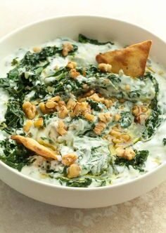 Healthy Spinach Yogurt Dip There are certain recipes I always want to have in the refrigerator. Something creamy. Something fresh. Something I can scoop up with a piece of warm pita or spoon onto a plate of grilled chicken and vegetables. This Healthy Spinach Yogurt Dip is exactly that kind of recipe. It's cool, creamy, garlicky, and packed with spinach, but it doesn't feel heavy. The yogurt gives it a wonderfully tangy base, while fresh herbs, lemon, and garlic bring everything to life. I first made this when I wanted something a little lighter than the usual creamy dips. I had some spinach and yogurt in the refrigerator and decided to see what I could come up with. It turned out to be one of those recipes that feels almost too simple to be this good. I made a bowl over the weekend and put it on the table with warm pita, fresh vegetables, and a few other little dishes. My family kept going back for more. Someone used it as a dip. Someone else spooned it over grilled chicken. And before long, we were scraping the bottom of the bowl. That's when I knew I'd be making it again. What I love most is how versatile it is. You can serve it as an appetizer, spread it onto sandwiches and wraps, use it as a sauce for grilled meat, or simply keep a container in the refrigerator for an easy snack. And because the ingredients are so simple, it's the kind of recipe you can make whenever you happen to have spinach and yogurt on hand. 💚 Why You'll Love This Spinach Yogurt Dip Creamy without feeling overly heavy Packed with spinach Fresh and tangy Easy to make Requires simple ingredients Great for meal prep Delicious with pita and vegetables Works beautifully as a sauce or spread Naturally vegetarian Easy to customize with herbs and spices It's one of those recipes where the simplest ingredients really do come together beautifully. 🛒 Ingredients For the Spinach Yogurt Dip 5 ounces (140 g) fresh baby spinach 1½ cups plain Greek yogurt 2 cloves garlic, finely minced or grated 2 tablespoons fresh lemon juice 2 tablespoons extra-virgin olive oil 2 tablespoons chopped fresh dill 2 tablespoons chopped fresh parsley ½ teaspoon salt ¼ teaspoon freshly ground black pepper ¼ teaspoon ground cumin Optional Garnishes Extra olive oil Fresh dill Chopped parsley Lemon zest Cracked black pepper A pinch of red pepper flakes Toasted sesame seeds For the best flavor, I recommend using thick, plain Greek yogurt. 🥬 Fresh or Frozen Spinach? You can use either. Fresh spinach gives the dip a bright, fresh flavor and beautiful green color. Frozen spinach is convenient and works well too, especially when you want to make the dip quickly. The most important thing is removing as much excess water as possible. Watery spinach can make the dip thin and dilute the flavor. 👩‍🍳 How to Make Healthy Spinach Yogurt Dip 1. Wilt the Spinach Place the fresh spinach in a large skillet over medium heat. You don't need much oil because the spinach will quickly release moisture as it cooks. Cook for about 2–3 minutes, stirring occasionally, until the spinach is completely wilted. Don't overcook it. You just want it soft enough to blend into the yogurt mixture. 💧 2. Remove Excess Water This is one of the most important steps. Transfer the wilted spinach to a fine-mesh strainer or clean kitchen towel. Press or squeeze out as much excess liquid as possible. Let the spinach cool for a few minutes. If you're using frozen spinach, thaw it completely and squeeze it extremely well. The drier the spinach, the thicker and creamier your finished dip will be. 🔪 3. Chop the Spinach Once the spinach is cool enough to handle, chop it finely. You can chop it very finely for a smooth dip or leave some slightly larger pieces if you prefer more texture. I like a little texture because it makes the spinach more noticeable in every bite. 🥣 4. Combine the Yogurt Ingredients Add the Greek yogurt to a mixing bowl. Stir in: Garlic Lemon juice Olive oil Dill Parsley Salt Black pepper Cumin Mix until everything is well combined. The lemon and garlic should already make the bowl smell amazing. 🥬 5. Add the Spinach Fold the chopped spinach into the yogurt mixture. Stir until the spinach is evenly distributed. Taste and adjust the seasoning. Need more brightness? Add another squeeze of lemon. Want more garlic? Add another small clove. Prefer more herbs? Add extra dill or parsley. This is a very forgiving recipe. ❄️ 6. Chill the Dip Cover the bowl and refrigerate for at least 30 minutes before serving. If you have more time, let it chill for a couple of hours. This gives the garlic, herbs, lemon, and spinach time to mingle with the yogurt. The flavor becomes even better as it rests. 🫒 7. Finish With Olive Oil Transfer the dip to a serving bowl. Make a little swirl across the top with the back of a spoon. Drizzle with extra-virgin olive oil. Finish with fresh dill, parsley, lemon zest, or a pinch of red pepper flakes. Then grab some pita and dig in. ⭐ Tips for the Best Spinach Yogurt Dip Squeeze the spinach really well This is probably the most important tip. Extra water can turn a thick dip into a thin one. Use thick yogurt Greek yogurt gives the dip a creamy, substantial texture. Don't go overboard with lemon Start with a little and add more after tasting. Let it rest The dip tastes good immediately, but chilling allows the flavors to develop. Taste before serving Yogurt varies in tanginess, so the amount of lemon and salt you need can vary too. Use fresh herbs when possible Fresh dill and parsley add a brightness that dried herbs can't quite replicate. 🍋 How to Customize the Flavor One of the best things about homemade yogurt dip is how easy it is to adjust. More Garlic Add another clove of finely grated garlic. More Lemon Add another teaspoon or two of fresh lemon juice. More Herbs Increase the dill and parsley. Spicy Add crushed red pepper flakes, cayenne, or finely chopped jalapeño. Smoky Add a pinch of smoked paprika. Mediterranean Add chopped cucumber, mint, and a little crumbled feta. Extra Creamy Stir in a spoonful of labneh or cream cheese. 🌿 Fresh Herb Options Dill and parsley are my favorite combination, but you can experiment. Try: Fresh mint Cilantro Chives Basil Tarragon Mint is particularly good if you're serving the dip alongside grilled lamb or chicken. 🥒 What to Serve With Spinach Yogurt Dip This dip is incredibly versatile. Serve it with: Warm pita bread Pita chips Cucumber slices Carrot sticks Bell peppers Celery Cherry tomatoes Radishes Crackers Grilled vegetables It's also fantastic as part of a Mediterranean-style appetizer platter. Add hummus, olives, feta, cucumbers, tomatoes, pita, and grilled vegetables. Put this spinach yogurt dip right in the middle. 🍗 Use It as a Sauce Don't limit this recipe to dipping. The yogurt base makes a fantastic sauce. Grilled Chicken Spoon it over grilled chicken breast or thighs. Chicken Souvlaki Serve it alongside grilled chicken skewers with pita and salad. Roasted Vegetables Drizzle it over roasted cauliflower, zucchini, eggplant, or potatoes. Grilled Fish A spoonful alongside grilled salmon or white fish adds freshness. Lamb The cool yogurt and herbs are wonderful with grilled lamb. Falafel Use it instead of or alongside traditional tahini sauce. 🥪 Use It as a Spread This is one of my favorite ways to use leftovers. Spread it onto: Sandwiches Wraps Pita pockets Toast Flatbread Add grilled chicken, cucumber, tomato, and red onion for an easy lunch. 🥗 Make a Quick Bowl Build a simple Mediterranean-inspired bowl with: Grilled chicken Spinach yogurt dip Cucumber Tomato Red onion Olives Feta Avocado Pita You can also add rice or quinoa if you're looking for a more substantial meal. 🥣 Make It Thicker If you want an especially thick dip, use very thick Greek yogurt or strain regular yogurt before making the recipe. You can also stir in a spoonful of labneh. The result is almost spreadable. Perfect for pita sandwiches and wraps. 🧄 Roasted Garlic Version For a softer, sweeter garlic flavor, replace the raw garlic with roasted garlic. Roast a few garlic cloves until soft and golden. Mash them into a paste and stir them into the yogurt. It's a little more work, but the flavor is incredible. 🌶️ Spicy Spinach Yogurt Dip For a spicy version, add: ½ teaspoon red pepper flakes A pinch of cayenne 1 tablespoon finely chopped jalapeño You can also drizzle a little chili oil over the top before serving. 🧀 Spinach Feta Yogurt Dip Add ¼–½ cup crumbled feta to the finished dip. The salty feta works beautifully with the tangy yogurt and spinach. This version is especially good served with warm pita. 🥑 Spinach Avocado Dip For an extra creamy version, mash half an avocado and stir it into the dip. Add a little extra lemon juice to keep the flavor bright. 🧊 Can You Make This Dip Ahead? Absolutely. In fact, I recommend it. The flavors improve after resting in the refrigerator. You can make it earlier in the day and keep it chilled until you're ready to serve. Just give it a good stir before serving. 🧊 How to Store Spinach Yogurt Dip Transfer the dip to an airtight container and refrigerate. For the best quality, enjoy it within 3–4 days. If a little liquid collects on the surface, simply stir it back in. Always keep dairy-based dips refrigerated and avoid leaving them at room temperature for extended periods. ❄️ Can You Freeze Spinach Yogurt Dip? I don't recommend freezing this dip. Yogurt can separate when frozen and thawed, resulting in a watery or grainy texture. It's much better to make a fresh batch and enjoy it from the refrigerator. Luckily, it only takes a few minutes to prepare. ❓ Frequently Asked Questions Can I use frozen spinach? Yes. Thaw it completely and squeeze out as much liquid as possible before adding it to the yogurt. Can I use regular yogurt? Yes, although Greek yogurt gives you a thicker dip. If using regular yogurt, you may want to strain it first. Can I use sour cream instead? Yes. You can replace some of the yogurt with sour cream for a richer flavor. Is this dip keto-friendly? It can fit into a low-carb or keto-style diet depending on the yogurt and serving size you use. Check the nutrition label of your yogurt and account for the carbohydrates in your individual portion. Is this dip vegetarian? Yes, provided the yogurt and other ingredients you use meet your dietary requirements. Can I make it without garlic? Absolutely. The garlic adds a lot of flavor, but the dip is still delicious without it. Can I add cucumber? Yes. Finely diced cucumber makes this dip more refreshing and gives it a tzatziki-inspired quality. Be sure to squeeze excess moisture from the cucumber first. Why is my dip watery? The spinach probably retained too much moisture, or the yogurt itself may be relatively thin. Squeeze the spinach thoroughly and use thick Greek yogurt. Can I make this dairy-free? Yes, use a thick unsweetened dairy-free yogurt alternative. The final flavor and texture will vary depending on the brand. How can I make it smoother? For a smoother dip, blend the spinach and yogurt together in a food processor instead of chopping the spinach by hand. Can I add feta? Definitely. Feta adds a delicious salty, tangy flavor. What herbs go best with spinach yogurt dip? Dill and parsley are excellent choices. Mint, cilantro, chives, and basil can also work depending on how you plan to serve the dip. 📝 Recipe at a Glance Recipe: Healthy Spinach Yogurt Dip Prep Time: 10 minutes Cook Time: 3 minutes Chill Time: 30 minutes Total Time: About 43 minutes Servings: 6 Category: Appetizer / Dip / Sauce Cuisine: Mediterranean-inspired Method: Stovetop Ingredients 5 ounces fresh baby spinach 1½ cups plain Greek yogurt 2 cloves garlic 2 tablespoons lemon juice 2 tablespoons extra-virgin olive oil 2 tablespoons fresh dill 2 tablespoons fresh parsley ½ teaspoon salt ¼ teaspoon black pepper ¼ teaspoon cumin Instructions Wilt the spinach in a skillet for 2–3 minutes. Drain and squeeze out as much moisture as possible. Allow the spinach to cool slightly and chop finely. Combine Greek yogurt, garlic, lemon juice, olive oil, dill, parsley, salt, pepper, and cumin. Fold in the chopped spinach. Taste and adjust the seasoning. Cover and refrigerate for at least 30 minutes. Transfer to a serving bowl. Drizzle with olive oil. Garnish with fresh herbs and serve chilled. ❤️ The Dip I Keep Coming Back To I think the best recipes aren't always the ones with the longest ingredient lists. Sometimes it's the little bowl of something homemade sitting in the refrigerator that ends up becoming your favorite. That's exactly how I feel about this Healthy Spinach Yogurt Dip. It's simple enough to make without thinking too much about it, but flavorful enough that everyone notices when it hits the table. I love it with warm pita on a relaxed weekend afternoon. I love it beside grilled chicken for dinner. I love spooning it onto wraps. And honestly, I love opening the refrigerator and finding a little container waiting for me when I need a quick snack. The spinach gives it color and freshness. The yogurt makes it creamy and tangy. The garlic brings that savory bite. The lemon wakes everything up. And the herbs make the whole thing taste fresh. It's uncomplicated food, but sometimes uncomplicated is exactly what you want. So make a bowl, chill it well, warm up some pita, and put it in the middle of the table. Don't be surprised if the bowl comes back empty.